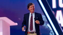 Tucker Carlson takes the stage during AmericaFest, the first Turning Point USA summit since the death of Charlie Kirk, in Phoenix, Arizona, U.S. December 18, 2025. REUTERS/Cheney Orr