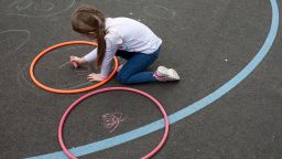 LONDON, ENGLAND - JUNE 04: Children maintain social distancing measures as the play in the playground at the Harris Academy's Shortland's school on June 04, 2020 in London, England. As part of Covid-19 lockdown measures, Harris Academy schools have taught smaller pods of students, to help maintain social distancing measures. With restrictions now lifting and the Government encouraging schools to re-open, the school staff has been working to find the best way to provide extra spaces while still retaining the correct social distancing measures and cleanliness requirements. This week, some schools across England reopened for some students, with children in reception, Year 1 and Year 6 allowed to return first. (Photo by Dan Kitwood/Getty Images)