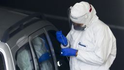 A health-care worker of Diagnostics Group collects swab samples for coronavirus testing at drive-thru mobile point in Krakow, Poland on October 10, 2020. Due to the increasing spread of COVID-19 in Poland the entire territory of the country will be designated as ' yellow ' zone as of Saturday, October 10. (Photo by Beata Zawrzel/NurPhoto via AP)